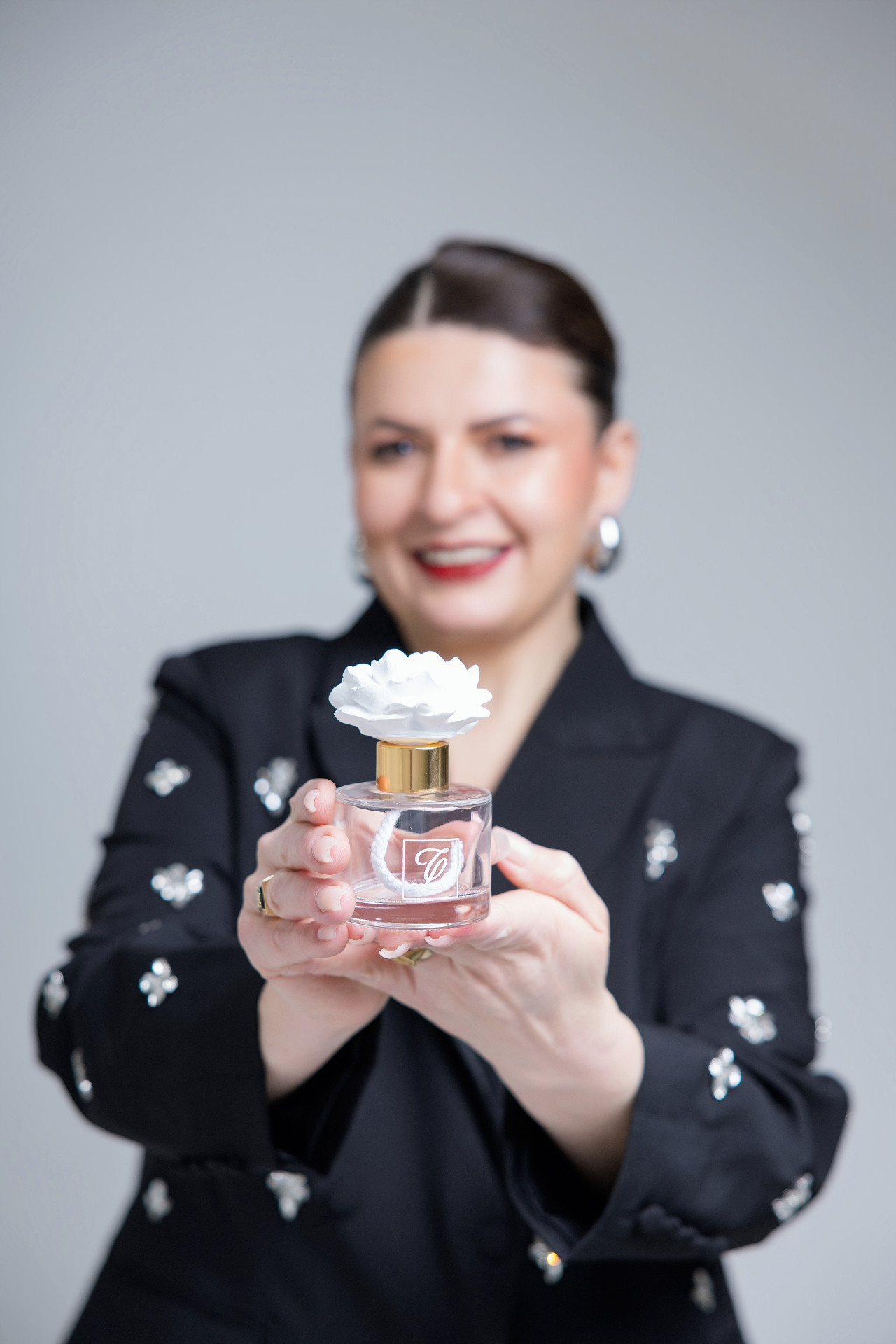 Perfumer Ciara Lessa holding a signature flower diffuser